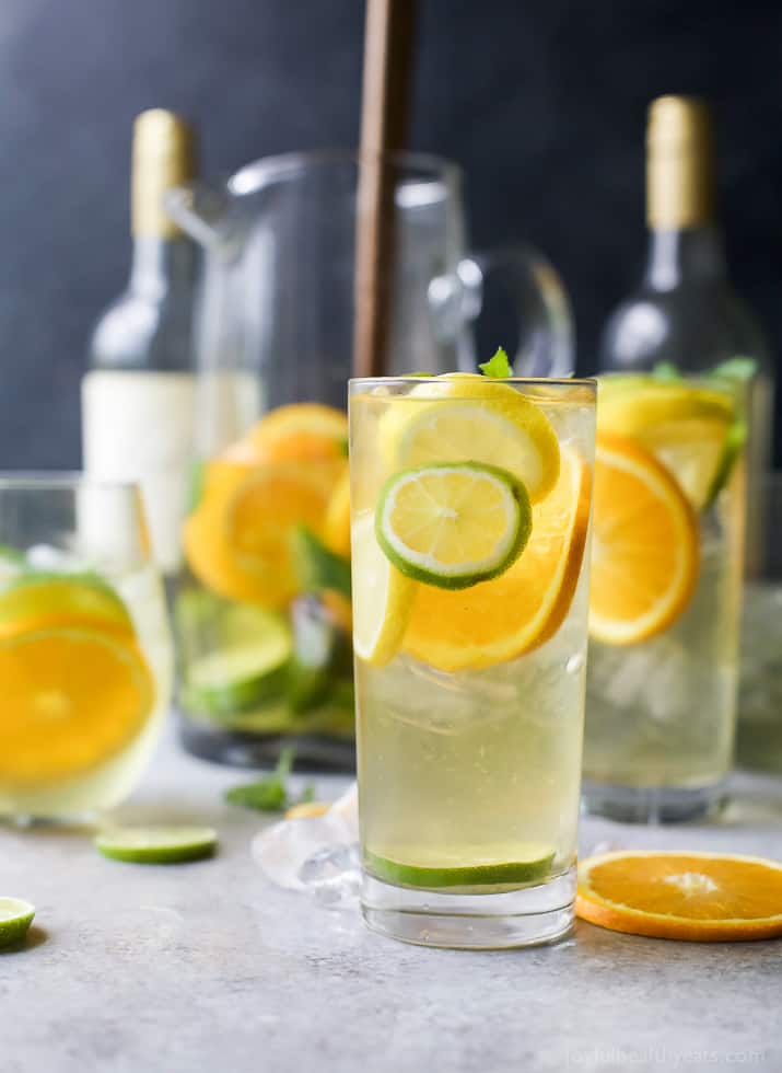 Tall glasses of Citrus White Wine Sangria with slices of citrus fruit