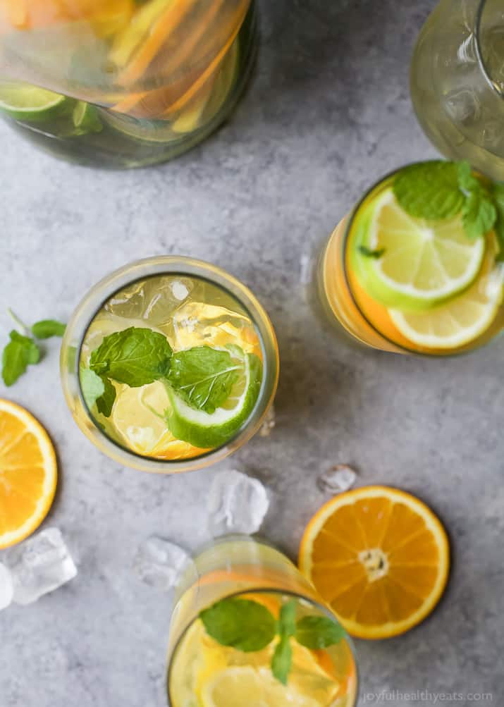 Top view of glasses of Citrus White Wine Sangria with slices of citrus fruit and fresh mint leaves