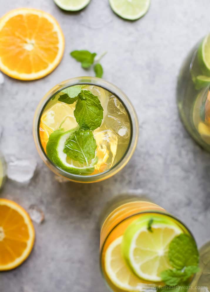 Top view of glasses of Citrus White Wine Sangria with sliced citrus and fresh mint