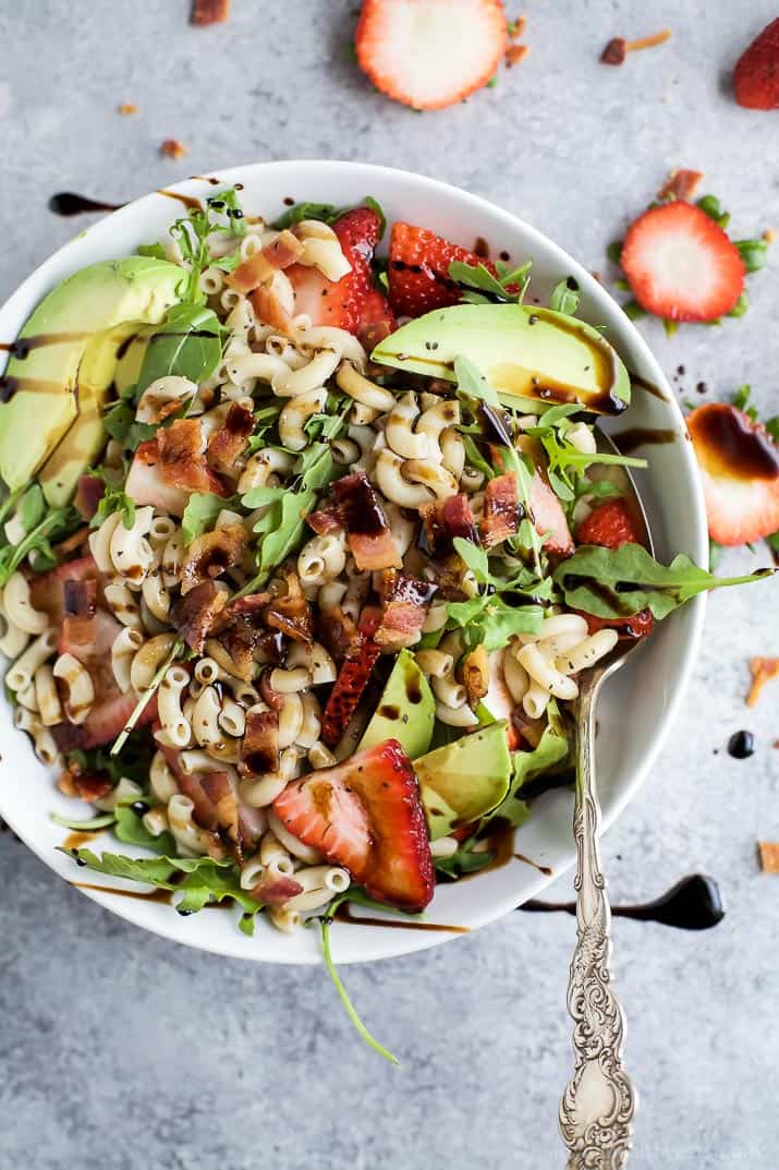 Easy Strawberry Avocado Pasta Salad tossed with fresh arugula, bacon, and a balsamic vinaigrette. The perfect pasta salad for those summer nights! | #ad | gluten free recipes