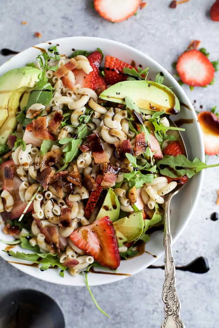 Easy Strawberry Avocado Pasta Salad tossed with fresh arugula, bacon, and a balsamic vinaigrette. The perfect pasta salad for those summer nights! | #ad | gluten free recipes