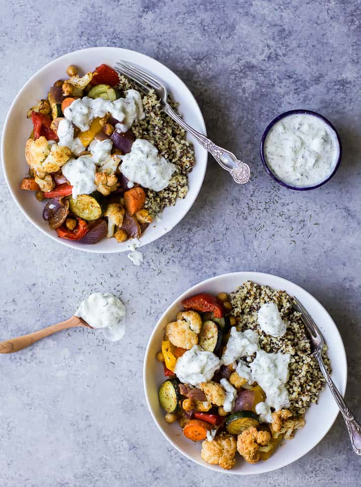 Roasted Vegetable Grain Bowls – a gluten free grain bowl filled with spiced roasted vegetables then covered in a creamy Tzatziki Sauce. A meal your family will love and perfect for meatless Monday!