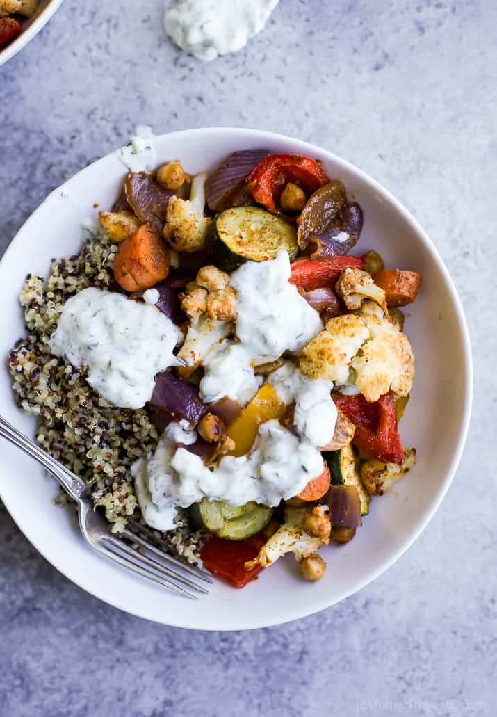 Roasted Vegetable Grain Bowls – a gluten free grain bowl filled with spiced roasted vegetables then covered in a creamy Tzatziki Sauce. A meal your family will love and perfect for meatless Monday!