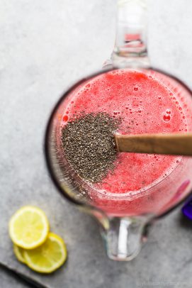 overhead photo of homemade raspberry lemonade with chia seeds in it