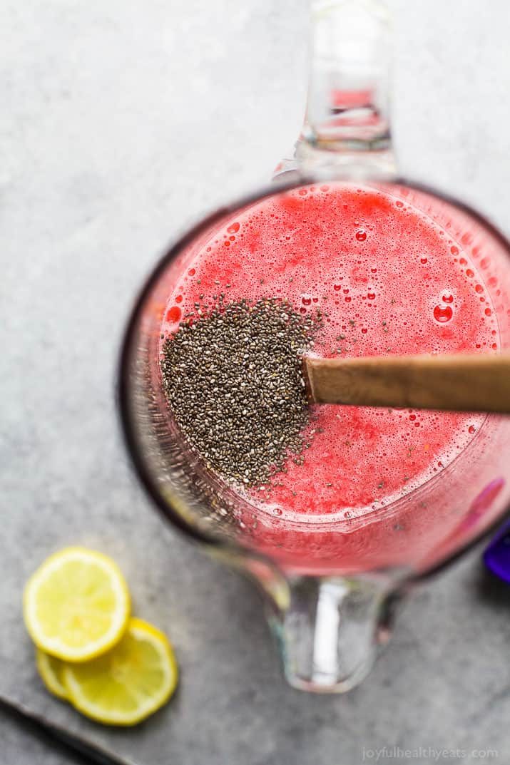 Top view of Chia Seed being stirred into a pitcher of Chia Raspberry Lemonade Spritzer