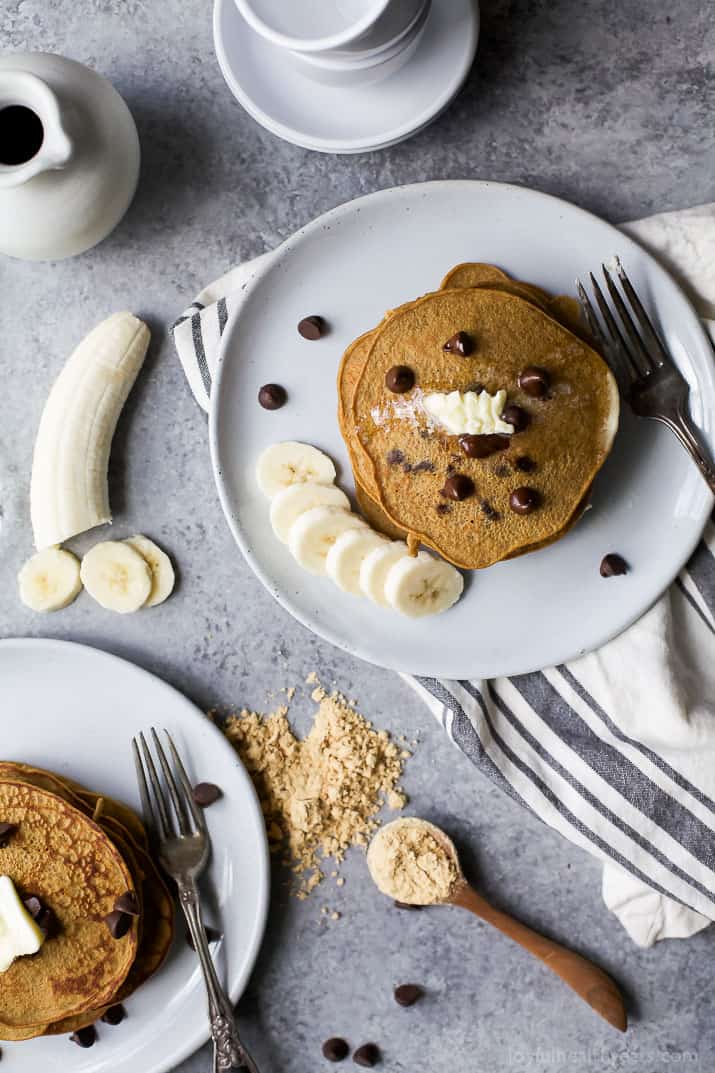 Top view of Flourless Peanut Chocolate Chip Pancakes on a plate with Bananas