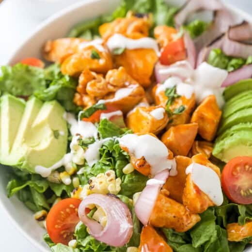 Buffalo chicken salad with Ranch dressing in a bowl.