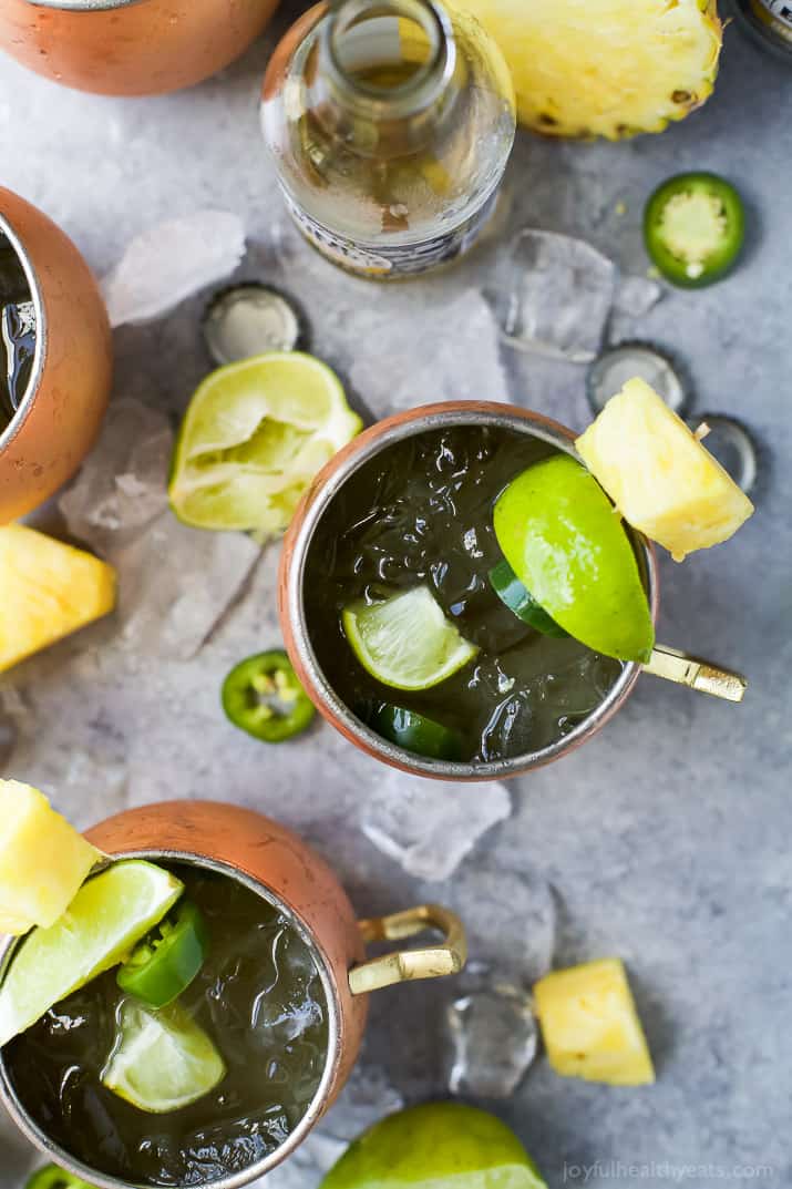 A Pineapple infused Moscow Mule topped with Jalapeno in copper cups