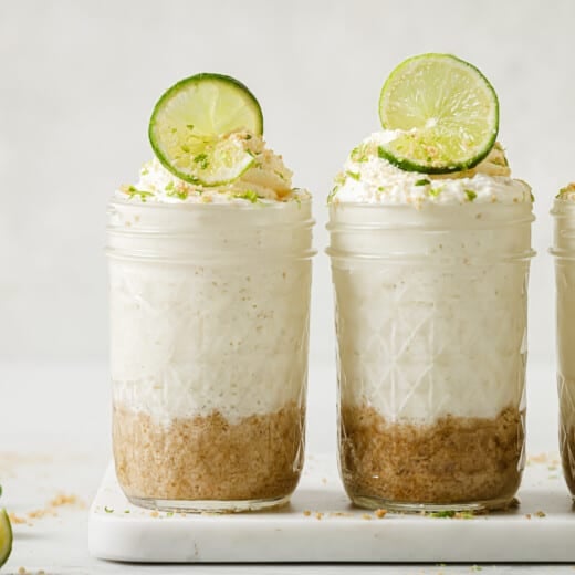 Three key lime cheesecakes in mason jars.