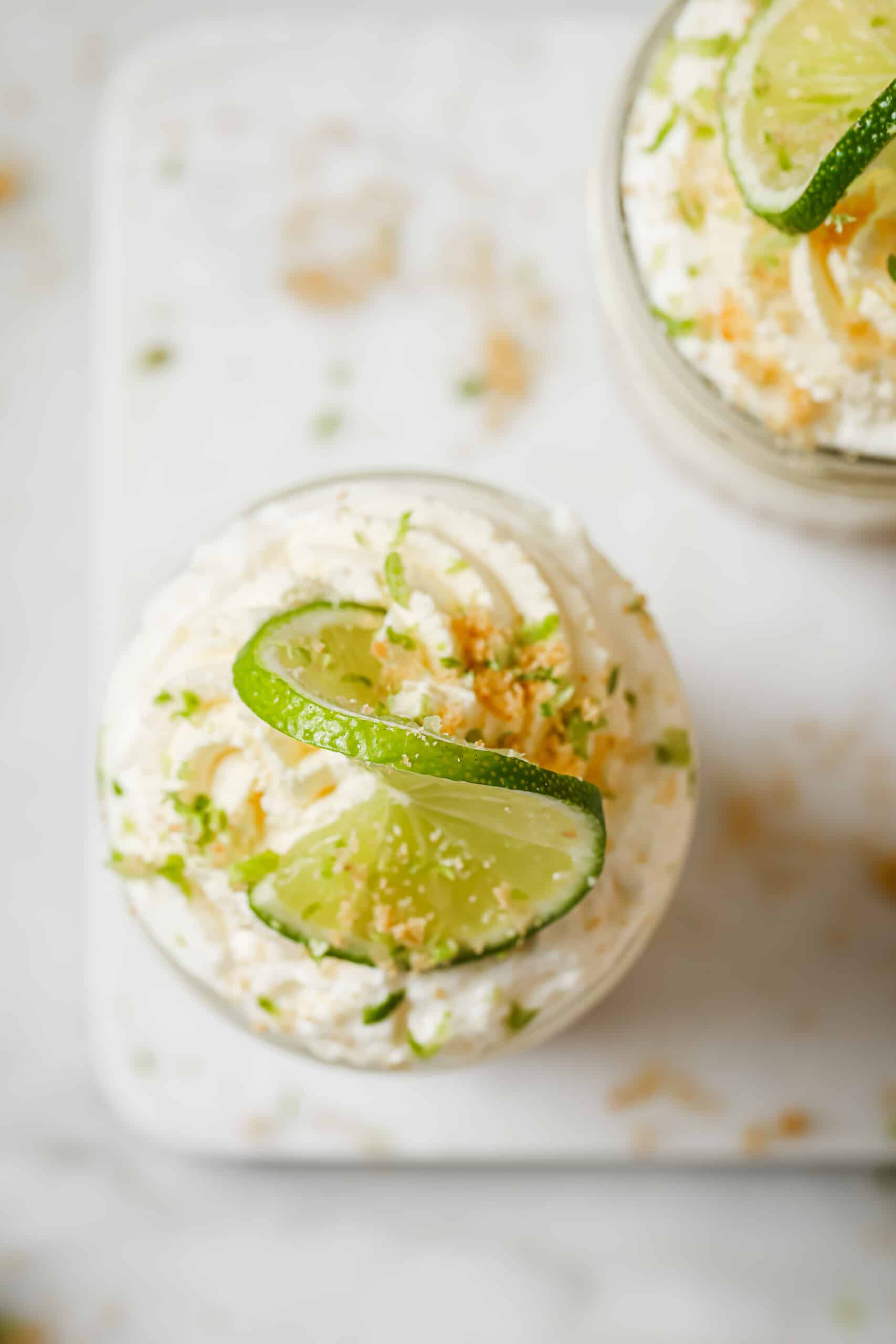 Overhead photo of a no-bake cheesecake in a jar with whipped cream. 