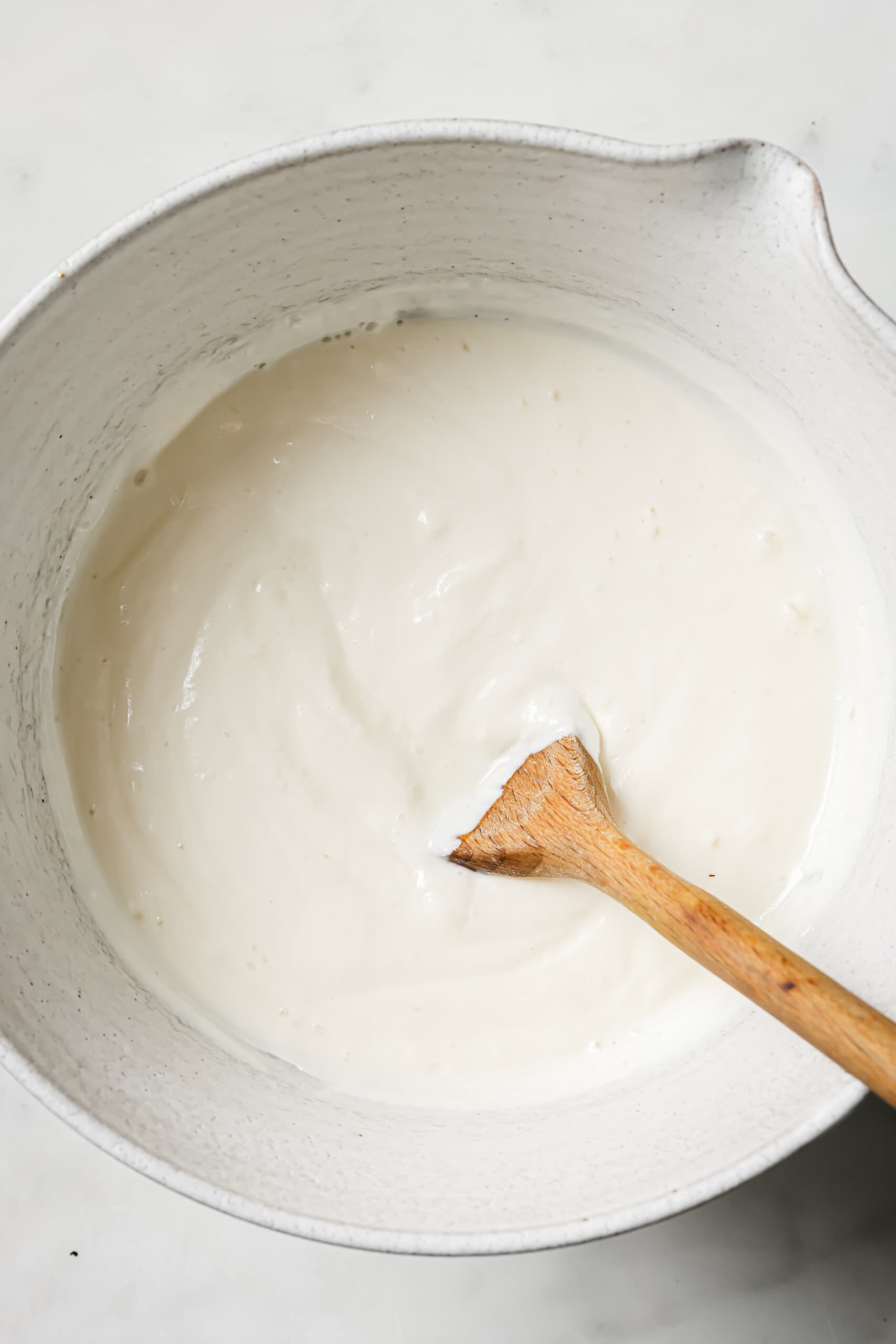 Smooth cheesecake filling in a bowl.