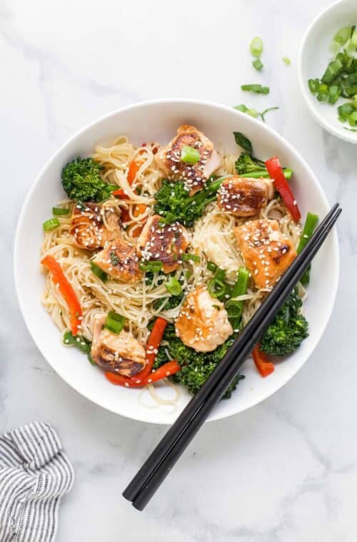 Teriyaki salmon stir fry with rice noodles and vegetables.