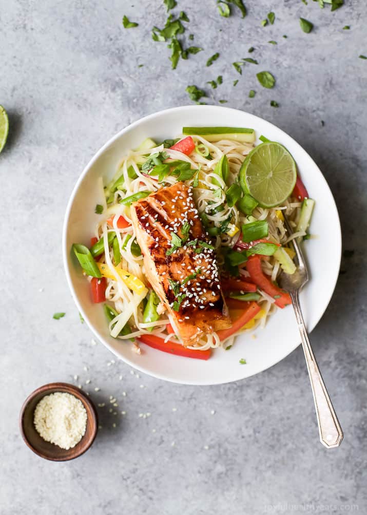 Easy Teriyaki Salmon served on a bed of Asian Noodles made with brown rice noodles, fresh veggies and a homemade Asian Sesame Dressing! A light, simple refreshing recipe for the summer! | gluten free recipes