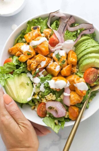 Bowl of chicken salad with grilled veggies and Ranch dressing.