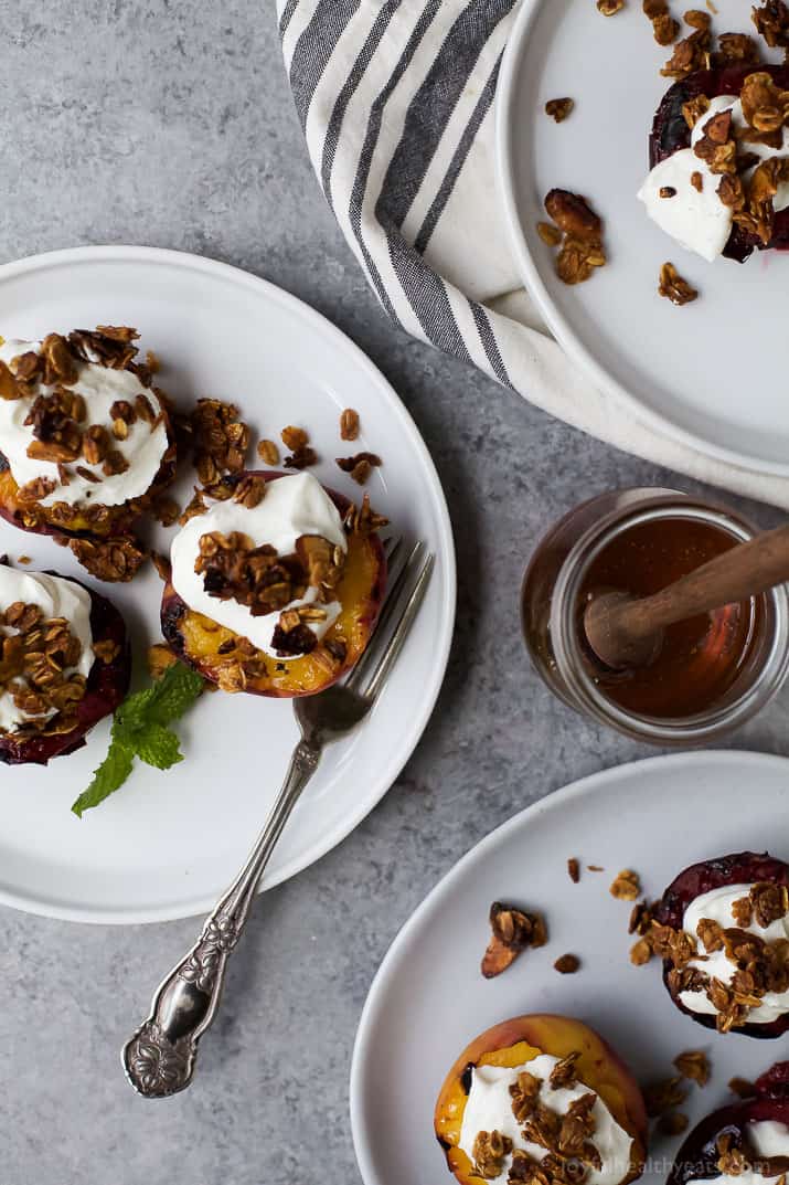 Top view of Grilled Stone Fruit halves topped with Vanilla Yogurt & Homemade Granola on a plate