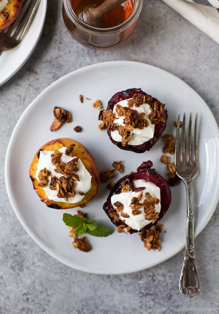 Top view of Grilled Stone Fruit halves topped with Vanilla Yogurt & Homemade Granola