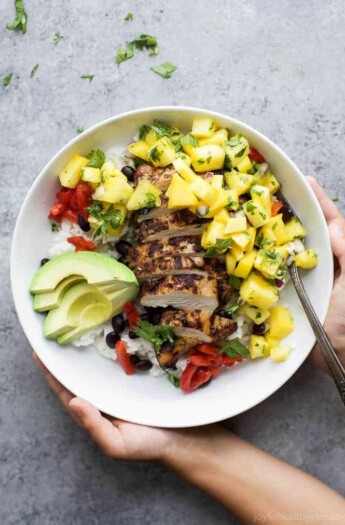 Head to Jamaica with this Grilled Jerk Chicken Bowls topped with Mango Pineapple Salsa served over Coconut Rice. An easy gluten free weeknight meal your family will love! | #ad @justbarechicken