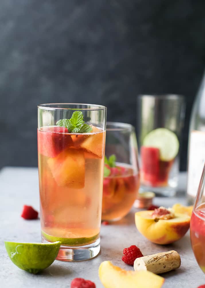 Rosé Wine with Homemade Fresh Fruit Cubes made with raspberries and peach - a perfect refreshing cocktail for the summer!