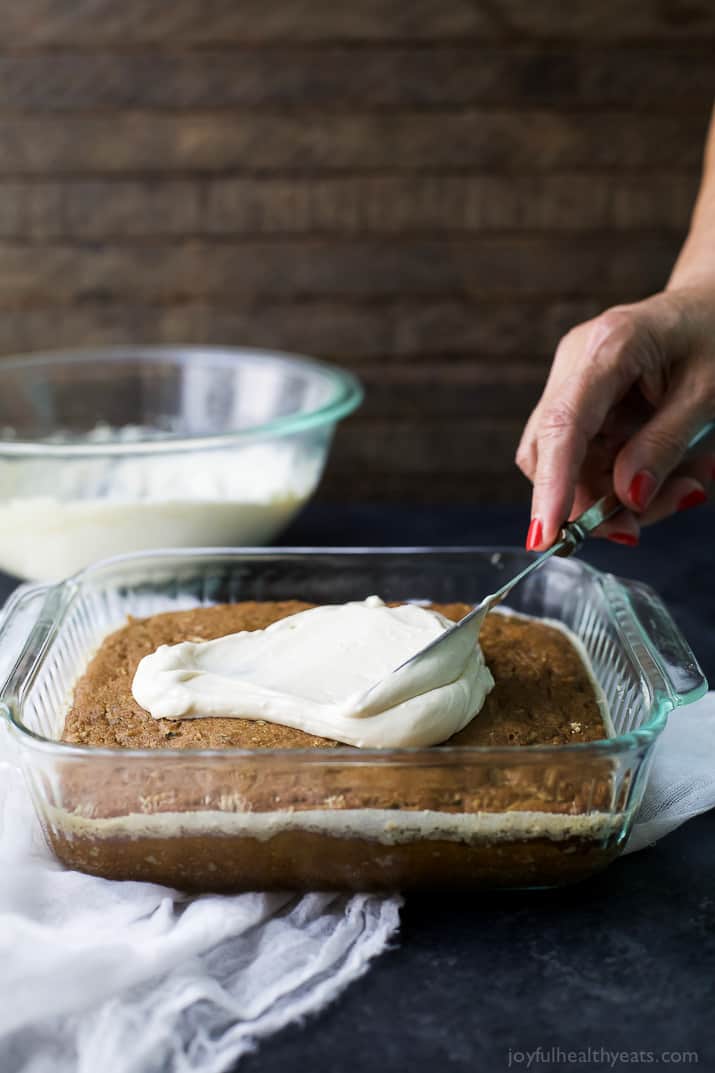 Moist Healthy Zucchini Cake made with applesauce and honey then topped with a light Cream Cheese Frosting! It's the ultimate dessert recipe or late night sweet treat!