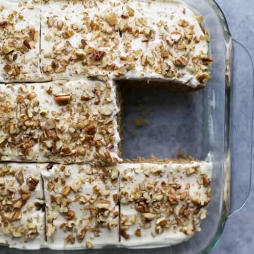 moist zucchini cake with cream cheese frosting in a baking dish