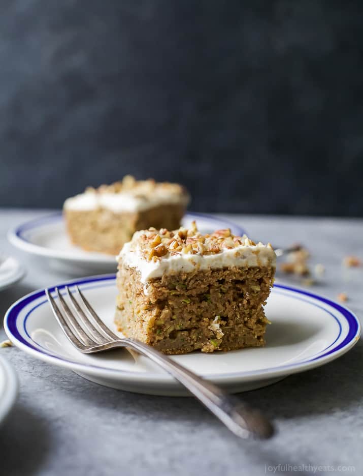 Moist Healthy Zucchini Cake made with applesauce and honey then topped with a light Cream Cheese Frosting! It's the ultimate dessert recipe or late night sweet treat!