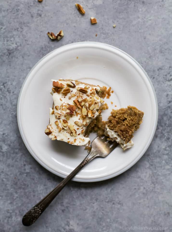 Moist Healthy Zucchini Cake made with applesauce and honey then topped with a light Cream Cheese Frosting! It's the ultimate dessert recipe or late night sweet treat!