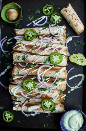 9 Cheesy Butternut Squash Chicken Taquitos drizzled with an Avocado Crema and topped with jalapenos. #UndeniablyDairy #ad @DairyGood
