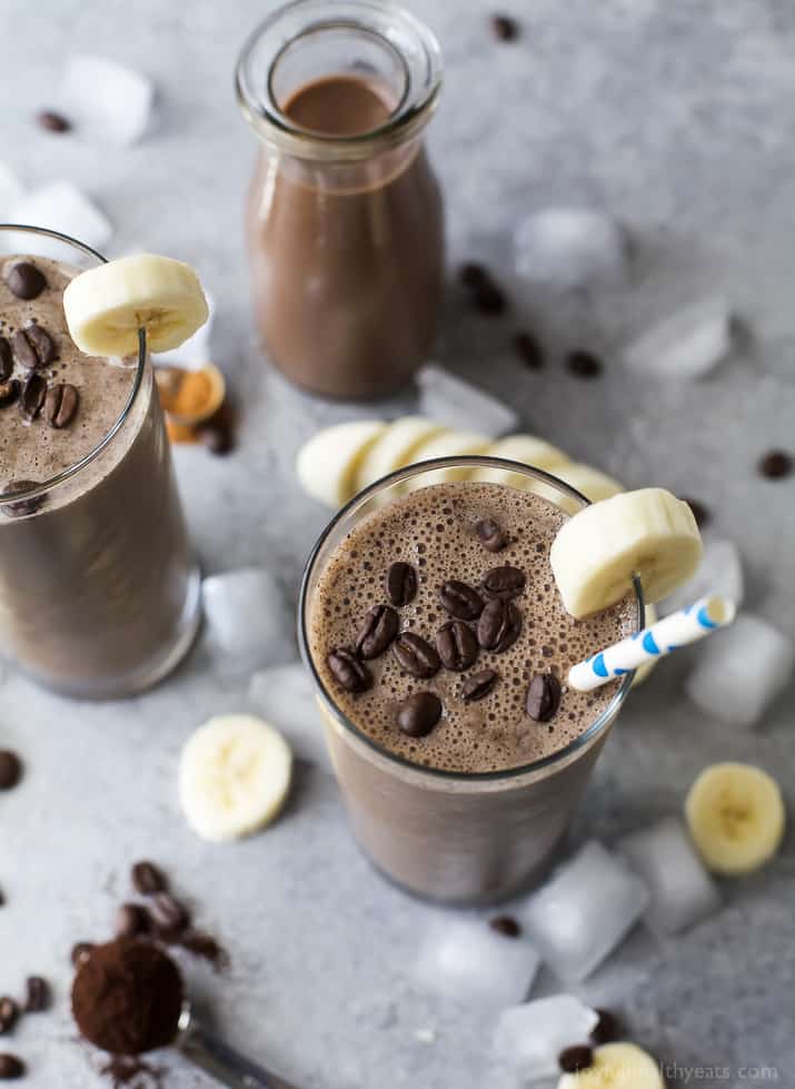 Two glasses of Cafe Mocha Smoothie with coffee beans on top