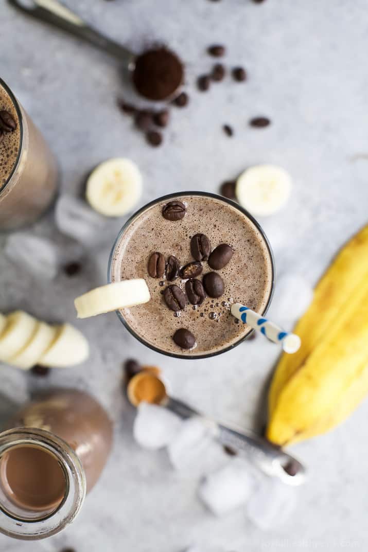 Top view of Cafe Mocha Smoothie in a glass topped with a banana slice and coffee beans