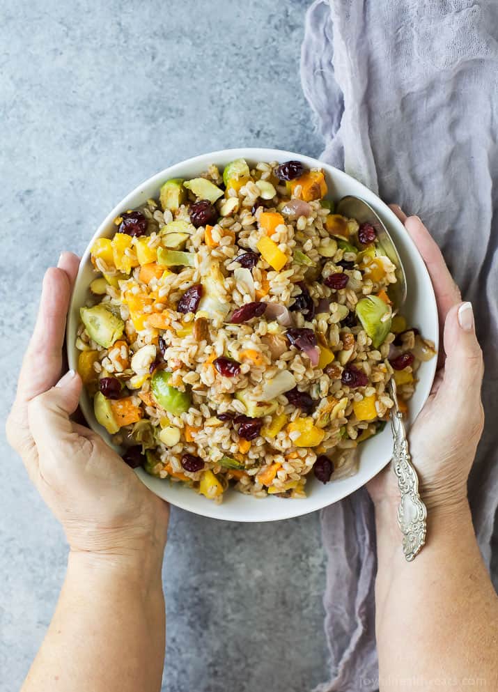Top view of a bowl of Harvest Butternut Squash Farro Salad with roasted fall vegetables, grains, and dried cranberries