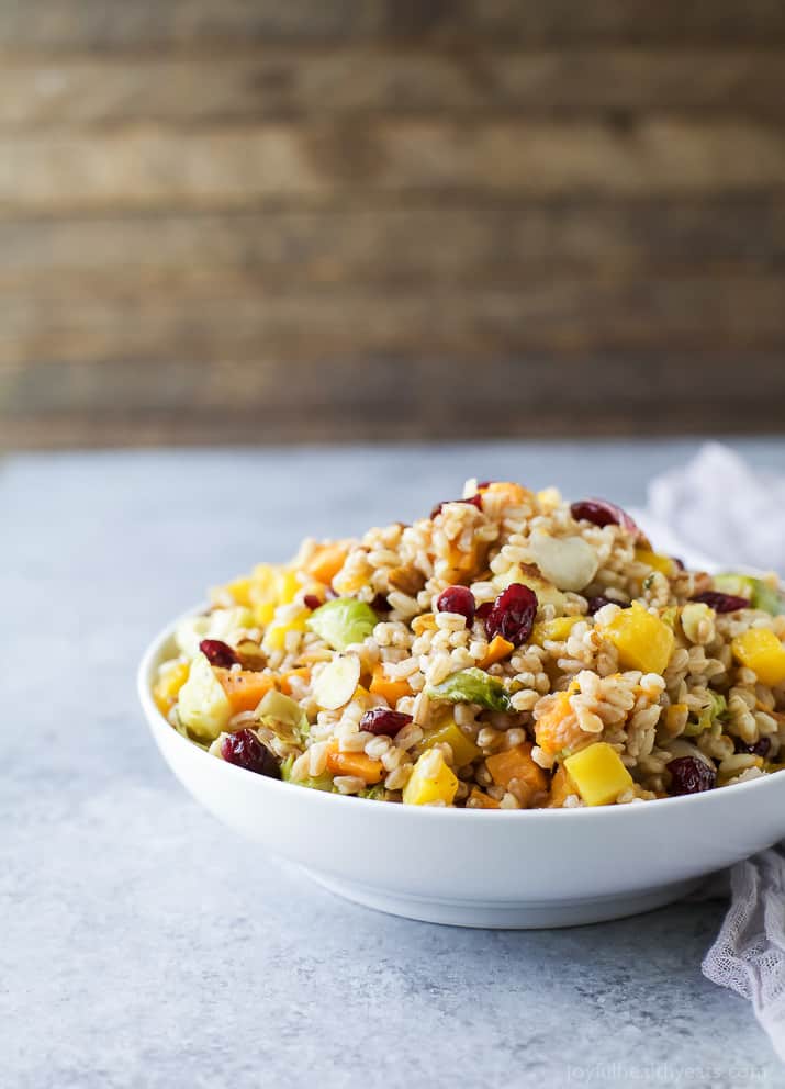 A bowl of Harvest Butternut Squash Farro Salad with roasted fall vegetables, grains, and dried cranberries