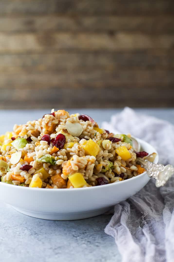A bowl of Harvest Butternut Squash Farro Salad with roasted fall vegetables, grains, and dried cranberries