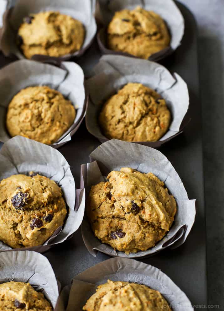 Healthy Carrot Cake Muffins with parchment liners in a muffin tin