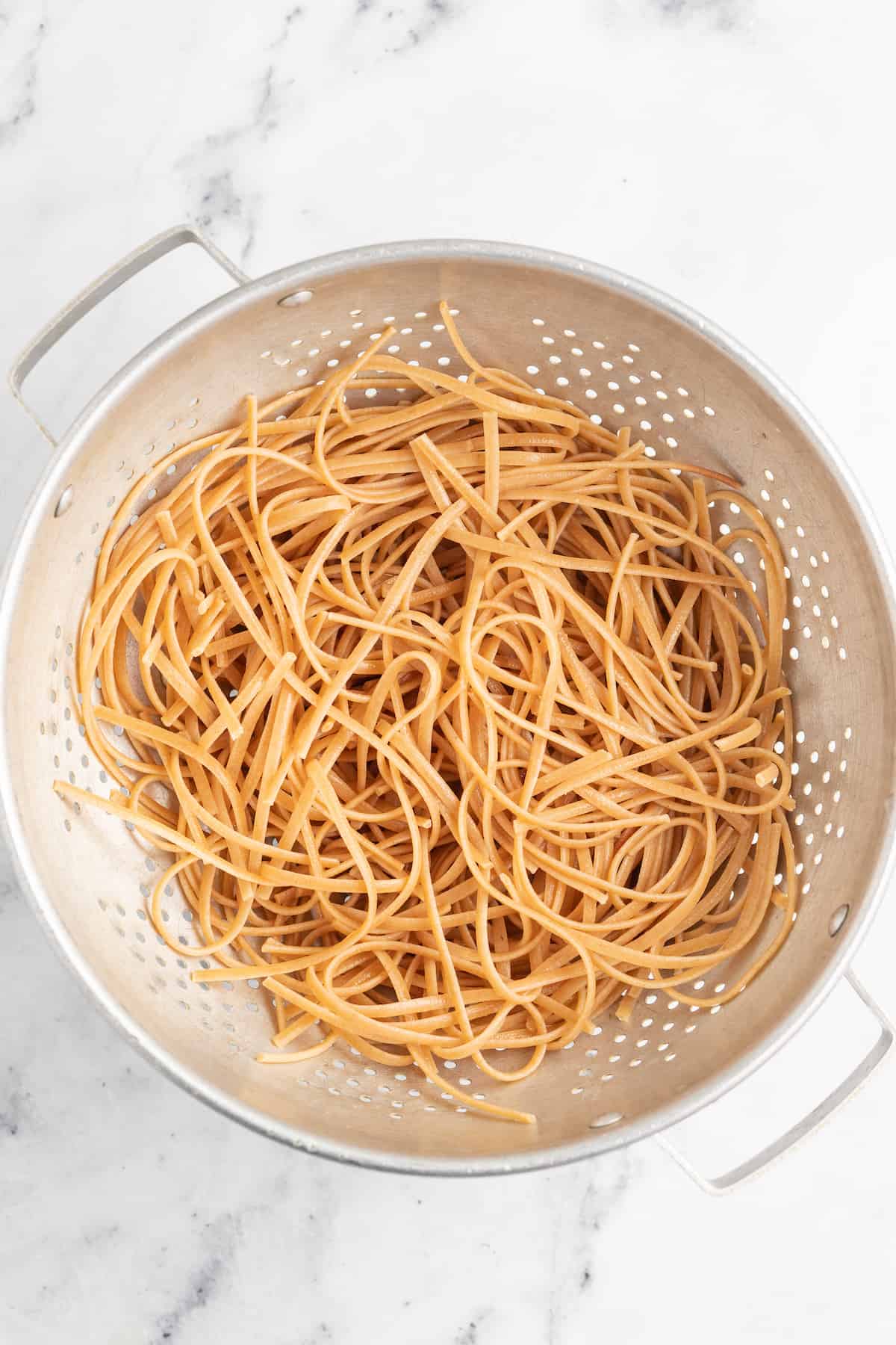 a colander with noodles