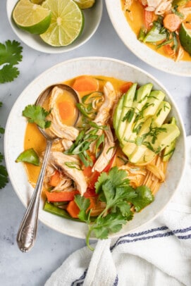 thai chicken noodle soup with avocado and fresh herbs