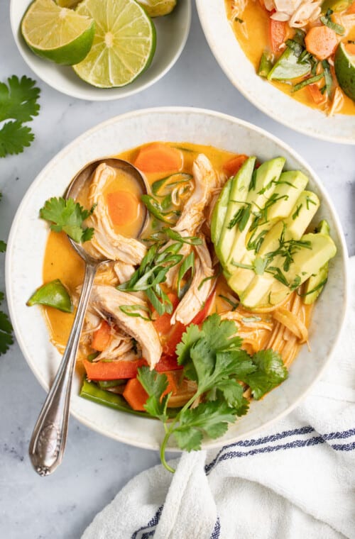 thai chicken noodle soup with avocado and fresh herbs