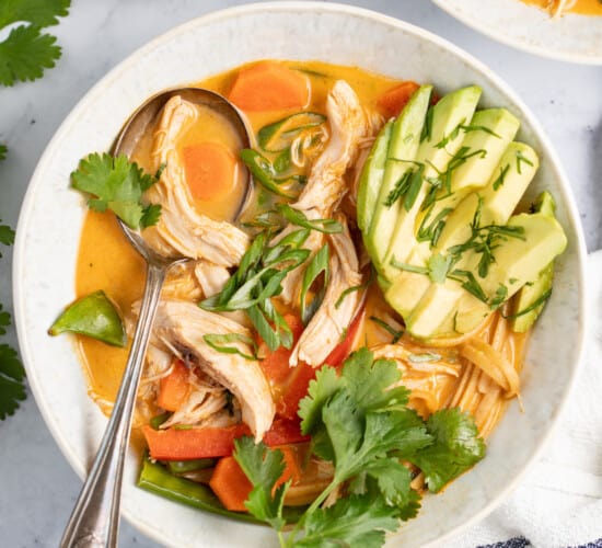 thai chicken noodle soup with avocado and fresh herbs