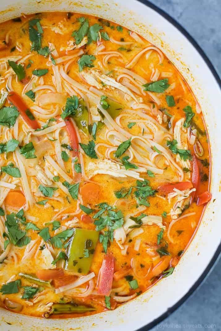 30 Minute Thai Chicken Noodle Soup filled with curry and coconut flavor, chicken, veggies and rice noodles! An epic soup recipe that will soon be your families favorite + it's gluten free!