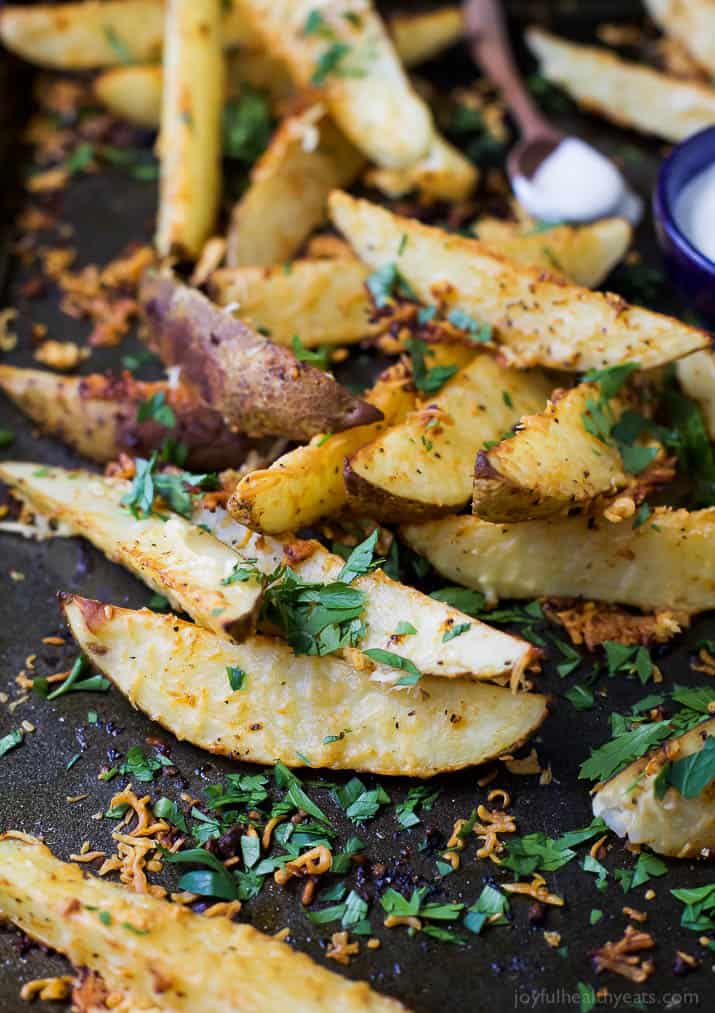 Garlic Parmesan seasoned Potato Wedges on a baking sheet