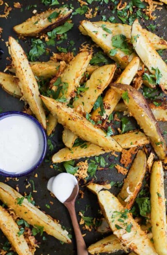 Garlic Parmesan seasoned Potato Wedges roasted in the oven until tender and crispy. These delicious potato wedges are guaranteed to be your new favorite appetizer or side dish!