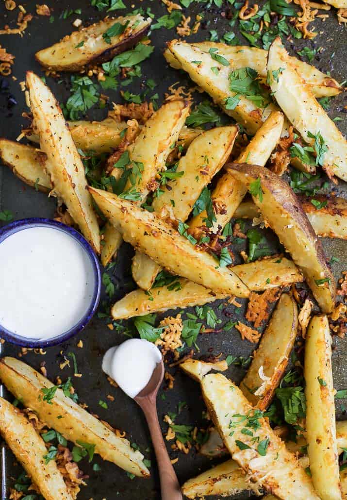 Garlic Parmesan seasoned Potato Wedges on a baking sheet