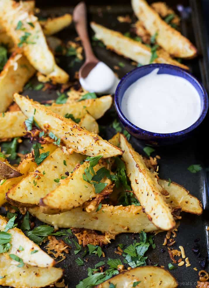 Garlic Parmesan seasoned Potato Wedges with a cup of creamy dipping sauce