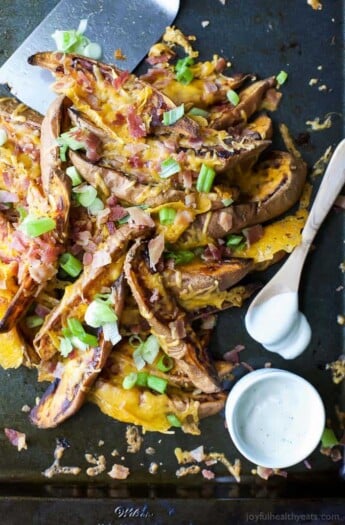 Loaded Sweet Potato Wedges, baked until crispy then covered with gooey cheese, crispy bacon and scallions. Appetizer. Side Dish. Main Dish. You decide! These loaded potato wedges are delicious, easy to make and perfect for game day!