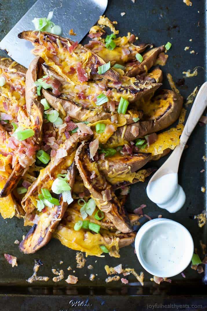 Loaded Sweet Potato Wedges topped with bacon, cheese and scallions