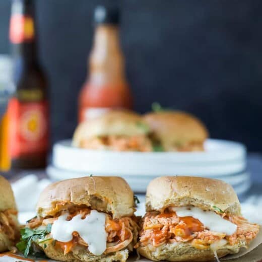 Two buffalo chicken sliders on a cutting board