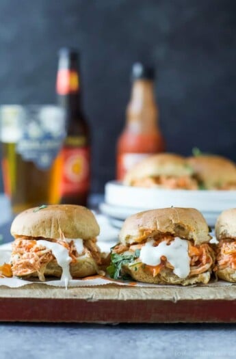 Three buffalo chicken sliders on a cutting board