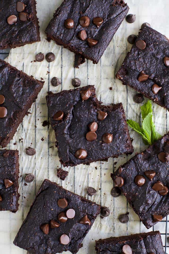 An Overhead Shot of Nine Gluten Free Brownies on a Piece of Parchment Paper