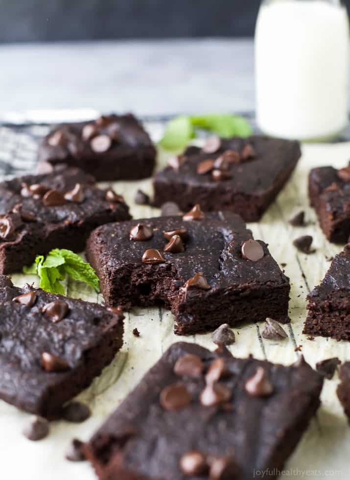 Gluten Free Brownies on a Lined Wire Rack with One Missing a Bite