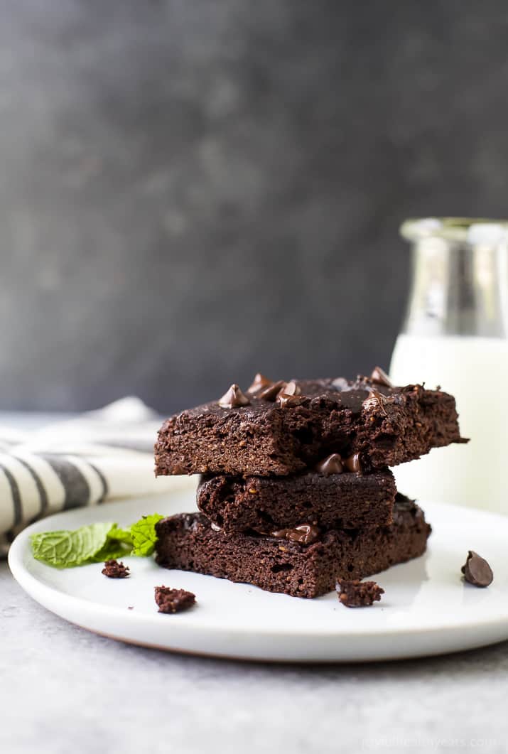 A Stack of Three Pumpkin Brownies on a Plate with Two Mint Leaves