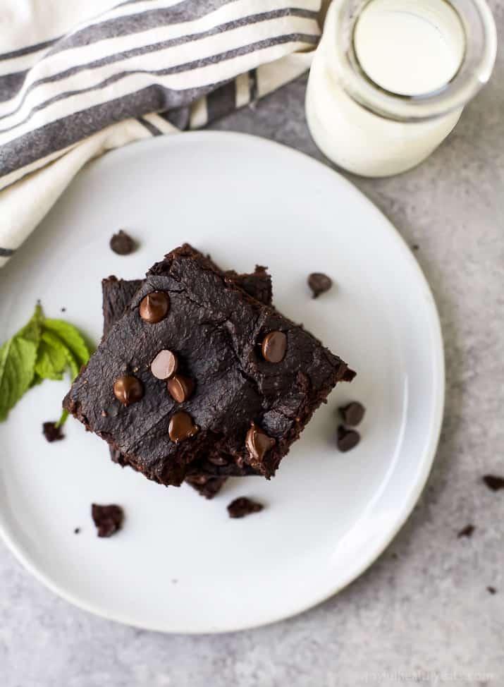 Two Fudgy Gluten-Free Chocolate Chip Brownies on a White Plate